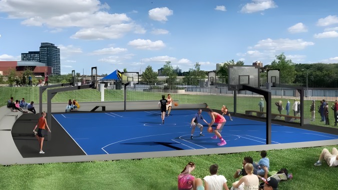 Schüler der Victoria Park High School beim Basketballspielen auf dem bunten Außenplatz mit moderner Gebäude im Hintergrund.