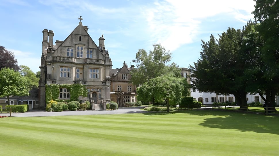 Das Schloss der Warminster School steht umgeben von gepflegtem Rasen und Hecken in einer landschaftlich gestalteten Anlage.