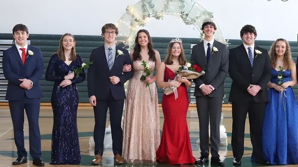 Schülerinnen und Schüler der West Catholic High School in formeller Kleidung bei einer Veranstaltung im Auditorium.