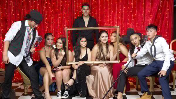 Eine Gruppe von Schülerinnen und Schülern des Western Springs College posiert vor einem roten Vorhang.