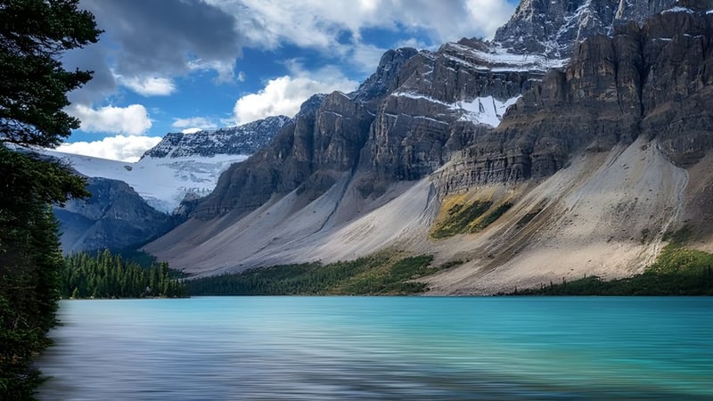 Der ruhige türkisfarbene See vor schneebedeckten Bergen in der Nähe der Westisle Composite High School.