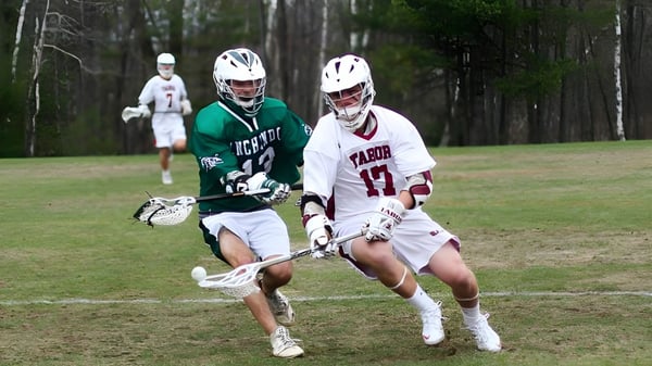 Zwei Lacrosse-Spielerinnen laufen auf einem Spielfeld im Grünen auf dem Campus der Winchendon School in New York City.
