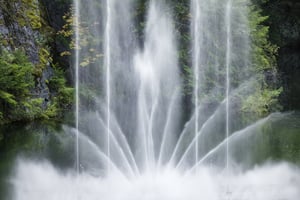 Elaborate and graceful fountain display in large formal garden