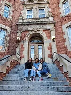 drei Schülerinnen auf der Treppe einer High School